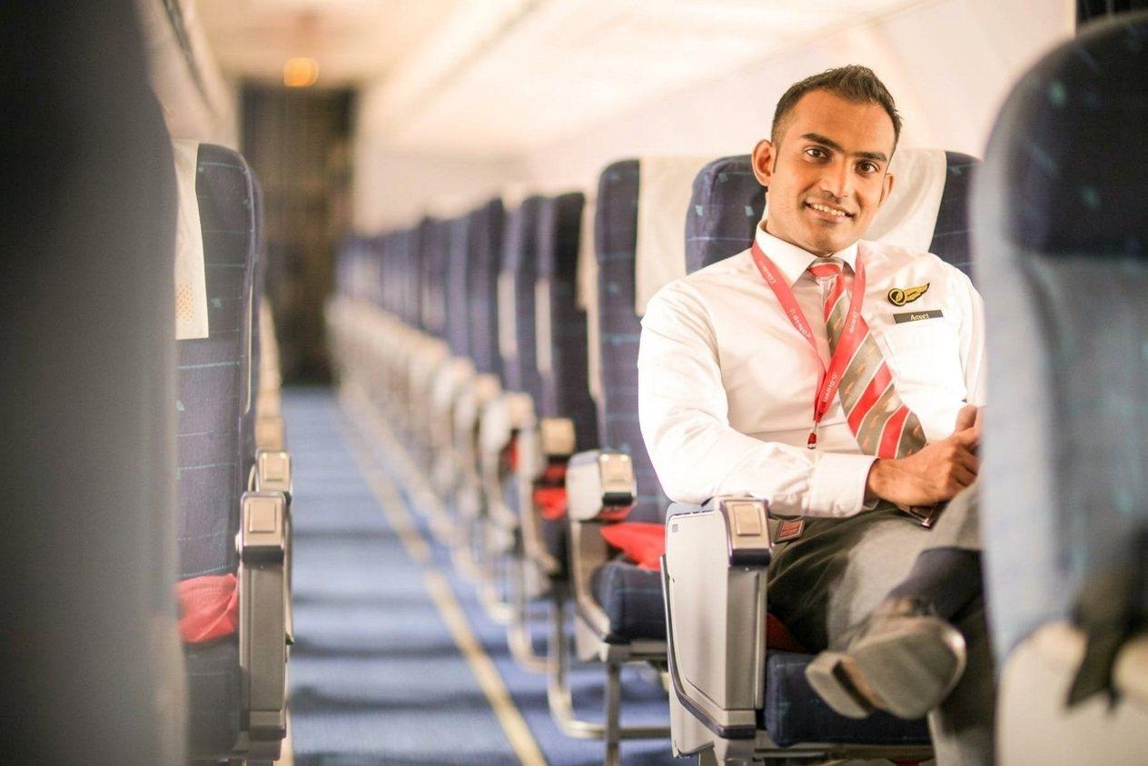 Arnab Aditya Das in cabin crew uniform aboard an aircraft
